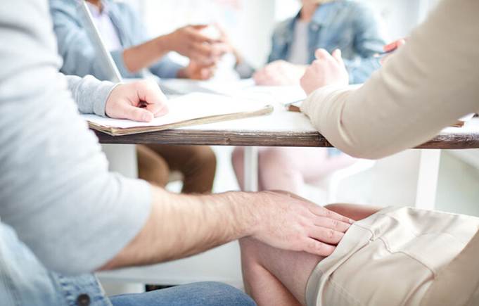 Grabbing womans thigh under the table at work - Sexual Harassement